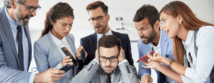 Employee stressed at desk under pressure from a narcissistic boss in a toxic corporate culture